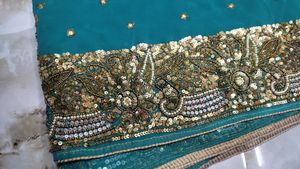 Teal Saree with Intricate Gold Embellishments