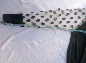 Chic Black Top with Polka Dot Sleeves
