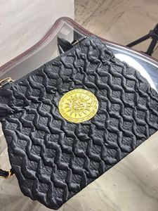 Stylish Black Textured Bag with Gold Emblem