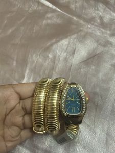 Elegant Gold Tone Coil Watch with Blue Dial