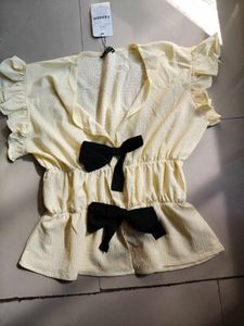 Cream Textured Peplum Top with Bows