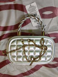 Elegant Silver Clutch with Gold Chain