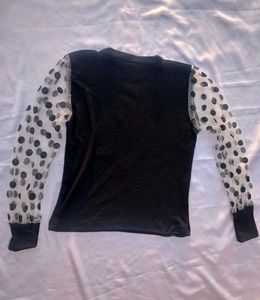 Chic Black Top with Polka Dot Sleeves