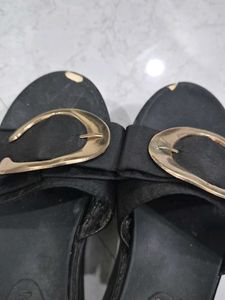 Stylish Black Slip-On Sandals with Gold Accent