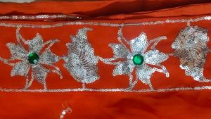 Elegant Orange Saree with Silver Embellishments