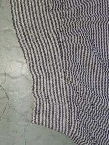 stripped knitted top with pom-poms on sleeve