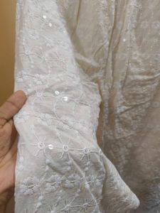 A kurta set with mirror work back design
