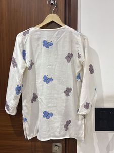white kurti with multicolored buttlerfy