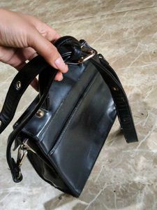 Chic Black Handbag with Gold Accent