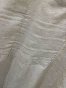 an elegant, cream-toned traditional Indian Kurta