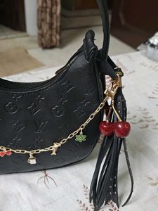 Chic Black Embossed Hobo Bag with Charms
