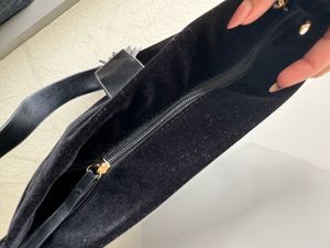 Chic Black Suede Shoulder Bag with Tassel Detail