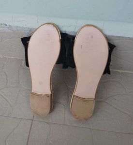 Chic Black Smocked Sandals with a Gold toned sole