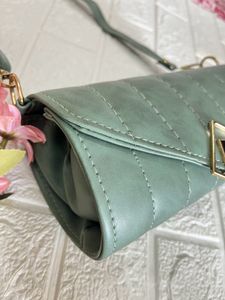 Green Roll shaped sling bag