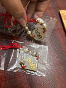 Pack Of 2 Resin Rakhi With A Money Holder