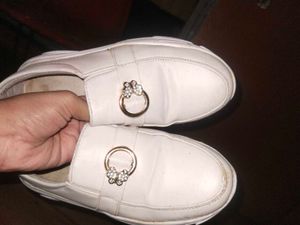 White slip-on shoes with embellishments