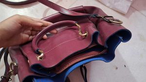 Charming Burgundy Handbag with Floral Embellishmen
