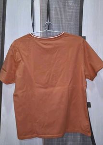 Orange Graphic T-Shirt with Ripped Jeans