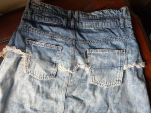 Y2K style distressed denim skirt