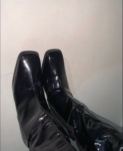 Knee length glossy boots