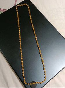Elegant Gold Beaded Necklace with Swastik