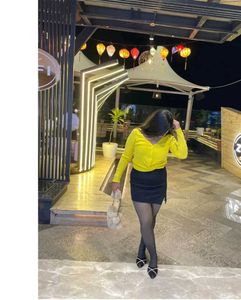 yellow top with black skirt