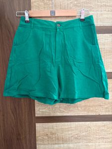 green button fastening shorts