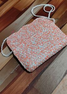 beautiful stylish orange and white colour sling ba