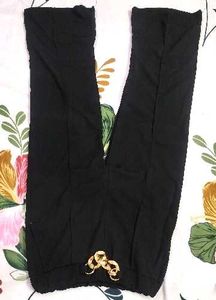 Aura Black Wide-Leg Pants with Gold Chain Detail