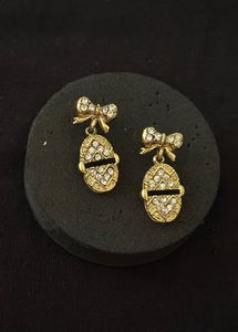 Gold Tone Bow Egg Dangle Earrings