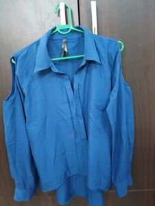 Royal Blue Top With Cold Shoulder Style. Can Be Styled Up For Office And Party Both. Bottom Style Of the Top Is High Low Style.
