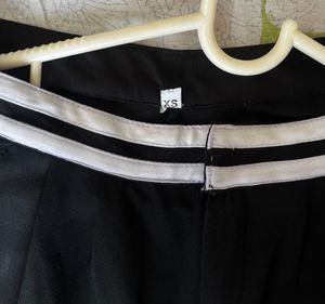 Black trousers with white stripe detail