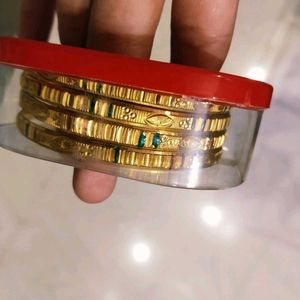 Set of Gold Bangles with Green Accents