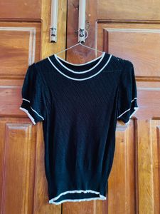 Black knit top with white trim
