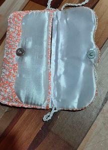 beautiful stylish orange and white colour sling ba