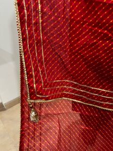 Red lehenga with matching dupatta and golden blous
