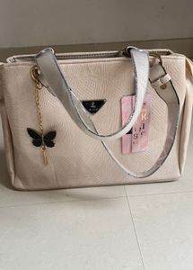 Stylish Beige Textured Handbag with Butterfly Char