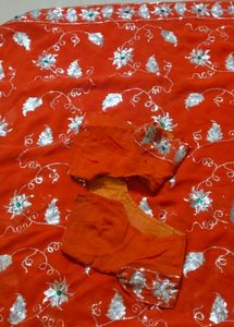 Elegant Orange Saree with Silver Embellishments