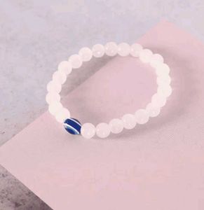 White Bead Bracelet with Blue Evil Eye Charm