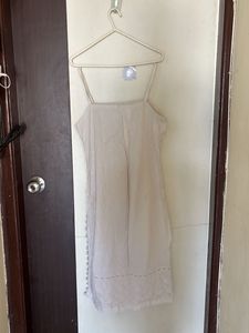white sleeveless kurta with pink stripped pants