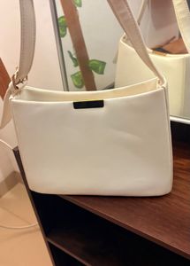 White Handbag With A Golden Buckle