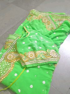 Vibrant Green Embroidered saree with stitched blou