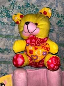 infant pillow and a teddy bear