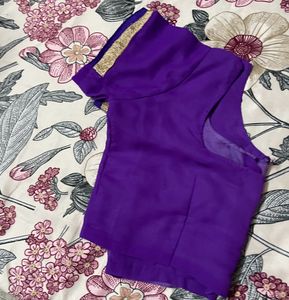 Pink colour saree with golden and purple border.