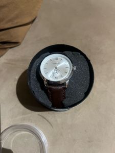 Elegant Silver Watch with Brown Leather Strap