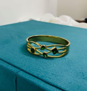 GOLD PLATED BANGLE WITH GREEN STONES