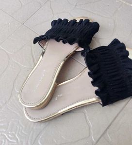 Chic Black Smocked Sandals with a Gold toned sole