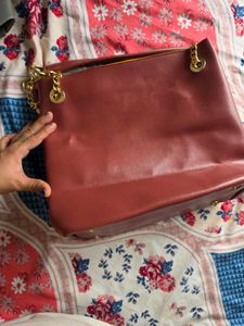 Chic Maroon Handbag with Gold Chain Accents
