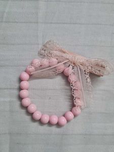 Two coquette lana coded bracelets