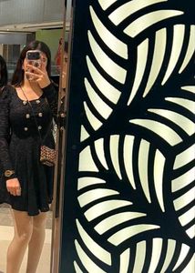 Elegant Black Dress with Gold Buttons
